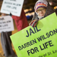 Demonstrators protest the shooting death of 18-year-old Michael Brown across from the police station on Nov. 17, 2014, in Ferguson, Mo.
Scott Olson/Getty Images